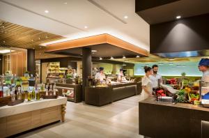 a group of chefs preparing food in a restaurant at Aminess Vival Maestral Hotel in Novigrad Istria