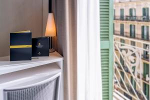 a table with two boxes on it next to a window at Hotel Serhs Carlit in Barcelona