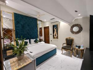 a hotel room with a bed and a chair at Grand Fort Boutique Hotel Dha in Karachi +22 photos