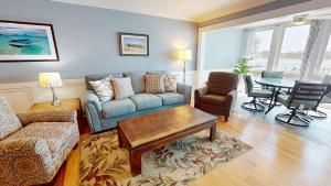 a living room with a couch and a table at Surf and Turf in Folly Beach