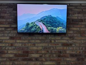 a flat screen tv hanging on a brick wall at El Gorrión in La Consulta