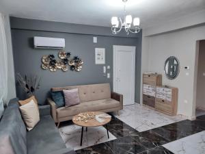 a living room with a couch and a table at Duba Apartments 2 in Alexandroupoli