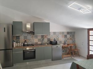 a kitchen with stainless steel appliances and a table at Artemide Residence Acquaviva in Acquaviva dʼIsernia