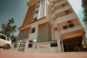 a building with a sign in front of it at Shri Devi Mookambika - Apart Hotel in Kollūru +21 photos