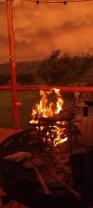 ein Feuer im Grill mit Flammen darin in der Unterkunft Amawa Domo - escapada romántica en las sierras in San Francisco del Monte de Oro + 29 Fotos