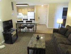 a living room with a couch and a table and a kitchen at LUC 2Bed Bayside Condo in Ocean City