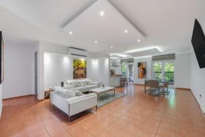 a living room with a white couch and a table at 3BR - Villa Papaya at North Coast Village in Dorado