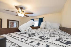 a bedroom with a bed with a ceiling fan at New! Special Intro Rate! Walkable, Fenced-In Yard in Charlotte