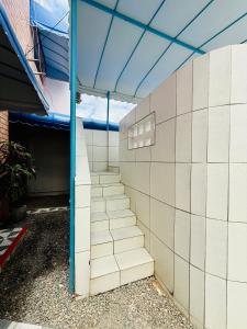 a set of stairs in a building with a blue ceiling at Guest House Rosa do Mar in Olinda
