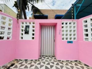 a pink building with a door in front of it at Guest House Rosa do Mar in Olinda