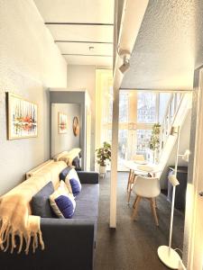 a bedroom with two beds and a table in a room at London Collection - Bayswater in London
