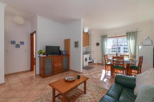 a living room with a couch and a table at Rocha Retreat - Praia Da Rocha in Portimão