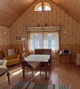 a living room with a table and a couch at Skillingaryds Gård in Skillingaryd