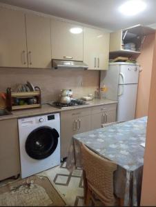 a kitchen with a washing machine and a table at Nicat in Quba +8 photos