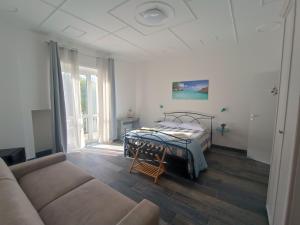 a living room with a bed and a couch at Porto Sicuro Hospitality in Cagliari