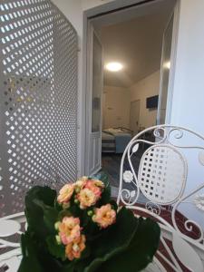 a table with a vase of flowers on it at Porto Sicuro Hospitality in Cagliari +33 photos