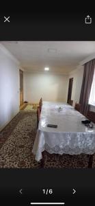 a room with a bed with a white table at Nicat in Quba