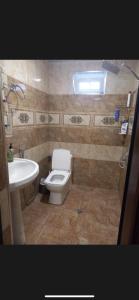 a bathroom with a toilet and a sink at Nicat in Quba