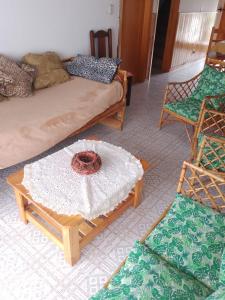 a living room with a couch and a table and chairs at Casa en la costa in Necochea