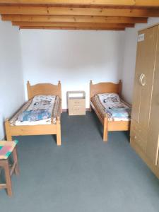 a room with two beds and a table and a cabinet at Casa en la costa in Necochea
