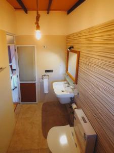 a bathroom with a white toilet and a sink at Art House in Dickwella +51 photos