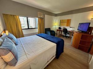 a hotel room with a bed and a desk and a television at Hotel Live & Lodge - Borges Lagoa 1179 - UH1003 in Sao Paulo