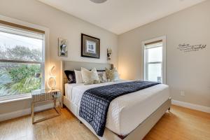 a bedroom with a large bed and two windows at Watch Dolphins St Augustine Gem Near Downtown! in Saint Augustine +20 photos