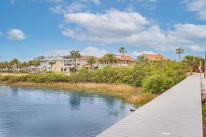 a boardwalk over a river with houses in the background at Watch Dolphins St Augustine Gem Near Downtown! in Saint Augustine