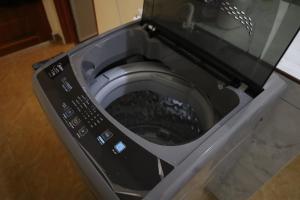 a close up of a washing machine in a bathroom at D'Bilal Zainal Homestay !Free Wifi, Free Netflix! in Bukit Baru +16 photos