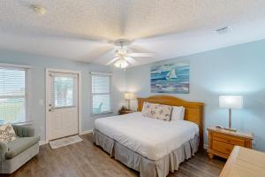 a bedroom with a bed and a ceiling fan at White Sands Retreat in Port Saint Joe +20 photos