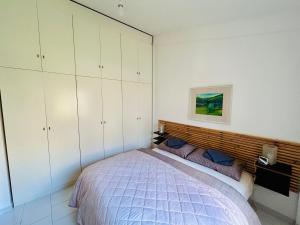 a bedroom with a bed and white cabinets at Apartment San Nicola Arcella in Saracena