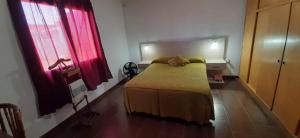 a bedroom with a bed with a dog laying on it at Casa la 12 in Miramar