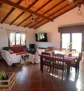 a living room with a red couch and a table at Casa la 12 in Miramar