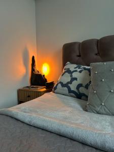 a bedroom with a bed with a lamp on a table at Bonnie & Clyde's hideout in Rīga