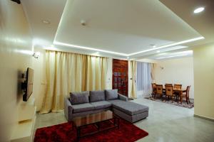 a living room with a couch and a table at Modern, cozy 3-bedroom villa in Gilgil