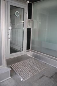 a sliding glass door on a building with a sidewalk at Air conditioned condo downtown with lake view in Hämeenlinna +37 photos