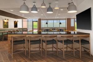 a bar in an office with chairs and tables at Fairfield by Marriott Inn & Suites Kansas City at The Legends in Kansas City +25 photos