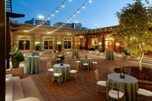 a courtyard with tables and chairs in a building at Renaissance Charlotte SouthPark Hotel in Charlotte