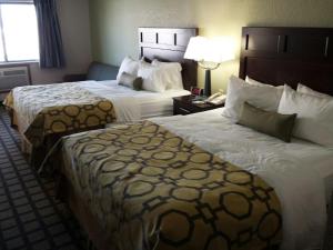 a hotel room with two beds and a phone at Park Inn by Radisson, Ames in Ames