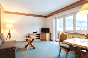 a living room with a couch and a table at Heiterwanger Hof Appartments in Heiterwang