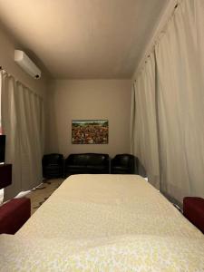 a bedroom with a large white bed in a room at casa greta in Viareggio +11 photos