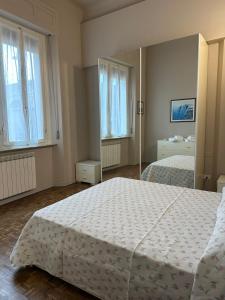 a bedroom with a large bed and a mirror at casa greta in Viareggio