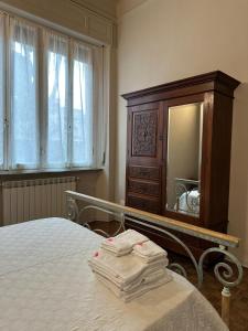 a bedroom with a bed with a dresser and a mirror at casa greta in Viareggio