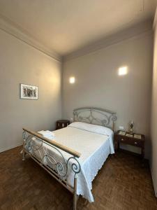 a bedroom with a bed with a white bedspread at casa greta in Viareggio