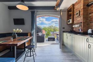 a kitchen with an open door leading to a patio at Domki Apartamentowe Chmielówka 2 in Chmielno