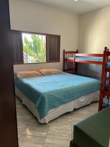 En eller flere senge i et værelse på Casa em Itanhaém