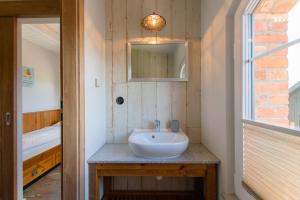 a bathroom with a sink and a mirror at Domki Apartamentowe Chmielówka 2 in Chmielno +82 photos