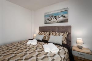 En eller flere senge i et værelse på La Vista Apartment