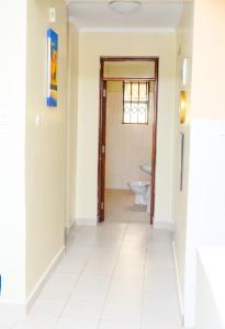 a hallway of a bathroom with a toilet at Lifestyle furnished 2 bedroom Mtwapa in Mombasa