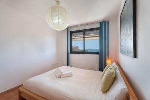 a bedroom with a white bed and a window at La Mathilda Playa Paraiso in Adeje +16 photos